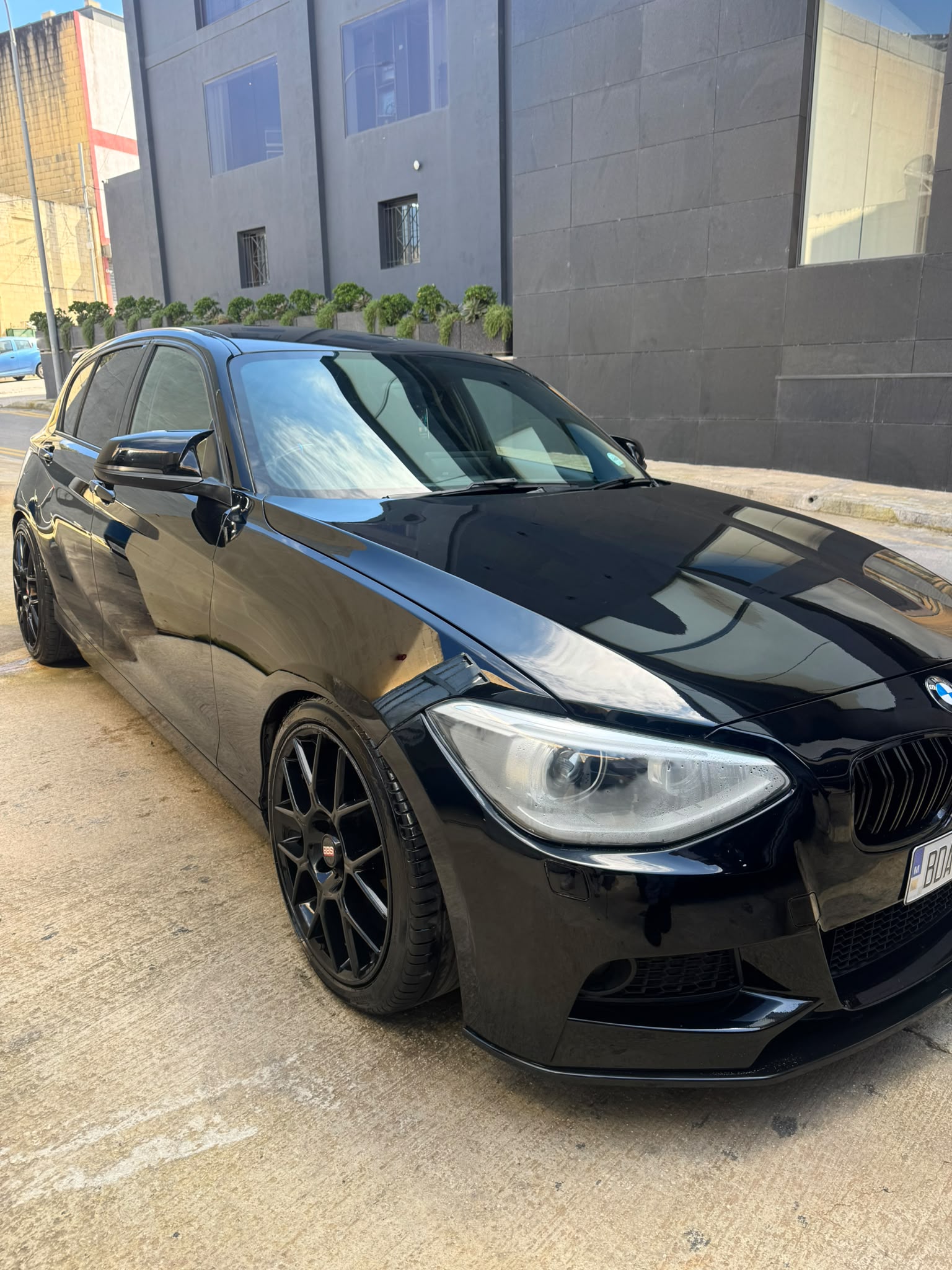 A freshly detailed black BMW outside in Malta